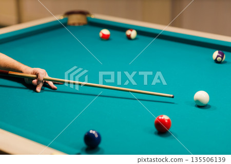 Billiard player at billiard table or snooker american billiards pool sport game. 135506139
