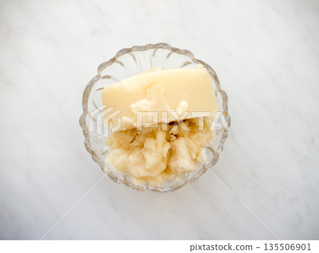 Honey in a plate on a marble background. Honey in a plate on a marble background. 135506901