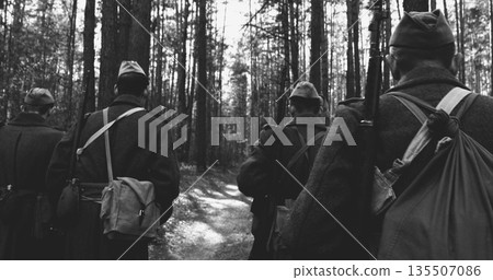 Russian Soviet Infantry Red Army Soldiers Of World War II Marching Walking Along Forest Lane Road In Spring Autumn Day. Group of Soldiers Marching In Country Road Russian Soviet Infantry Red Army Soldiers Of World War II Marching Walking Along Forest Lane Road In Spring Autumn Day. Group of Soldiers Marching In Country Road 135507086