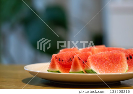 Small watermelons on the dining table Small watermelons on the dining table 135508216