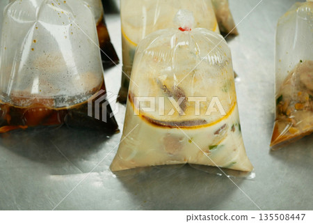 Liquid viands bags plastic and soups from street stalls in Thailand are typically packed in thick cellophane detail, which are securely package sealed with knots close-up. Reduces pack recyclability Liquid viands bags plastic and soups from street stalls in Thailand are typically packed in thick cellophane detail, which are securely package sealed with knots close-up. Reduces pack recyclability 135508447