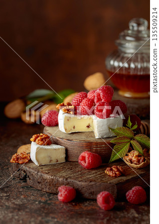 Camembert cheese with fresh raspberries, honey, and walnuts. Camembert cheese with fresh raspberries, honey, and walnuts. 135509214