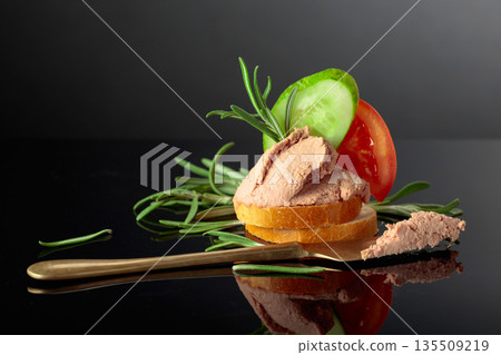 Bread slices with pate, tomato, cucumber, and rosemary. 135509219