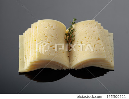 Cheese slices folded like an open book. 135509221