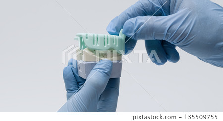 Dental technician handling bite registration mold Dental technician handling bite registration mold 135509755