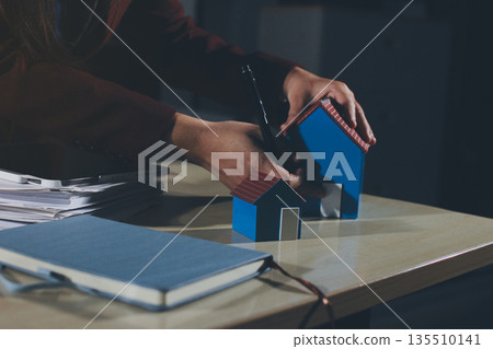 Customer signing a real estate contract in real estate agency. Customer signing a real estate contract in real estate agency. 135510141