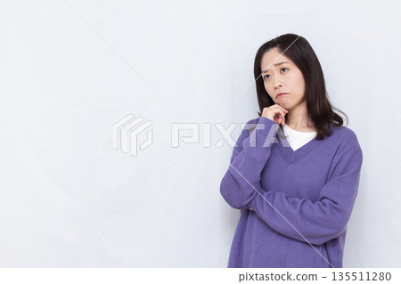 A woman who is seriously worried 135511280