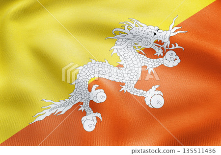 National flag of Bhutan with yellow and orange fields and powerful dragon symbol. 135511436