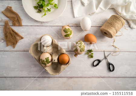 DIY Easter eggs with natural leaves, creating patterns on eggs using plants. Eco friendly colouring easter eggs DIY Easter eggs with natural leaves, creating patterns on eggs using plants. Eco friendly colouring easter eggs 135511558
