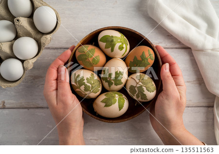 DIY Easter eggs with natural leaves, creating patterns on eggs using plants. Eco friendly colouring easter eggs 135511563