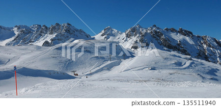 Ski lift in the Pizol ski area, snow covered mountains Graue Hoerner and Schwarze Hoerner, Switzerland. 135511940