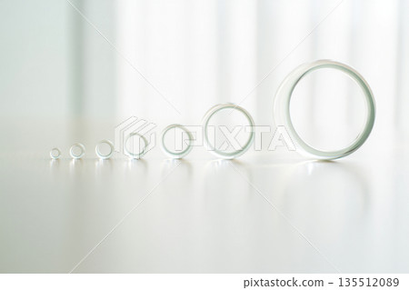 wedding rings on the glass 135512089