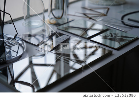glass stainless steel plates on kitchen stove 135512096