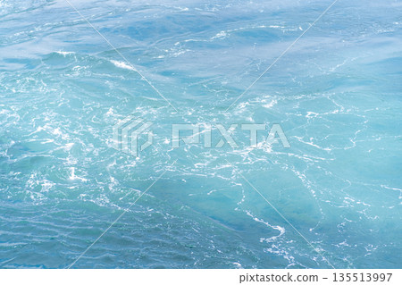 Clear turquoise waters of Prince Islands reflect sunlight as waves create soothing patterns along the shoreline, inviting relaxation and exploration. 135513997