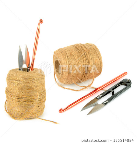 Jute twine with crochet hook and craft scissors isolated on white Jute twine with crochet hook and craft scissors isolated on white 135514884