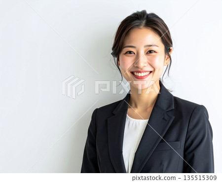 Portrait of a young female business person smiling on white background (with copy space) 135515309