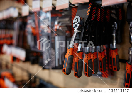 Tools neatly hanging on a wall, including a ratchet 135515527