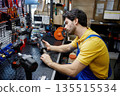 A man worker is working on a wrench in a store 135515534
