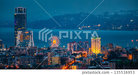 Batumi, Adjara, Georgia. Elevated view Ferris Wheel At Promenade In Miracle Park, Amusement City Park during Evening twilight night 135516953