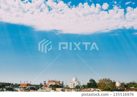 Taj Mahal at midday under clear blue sky with white cumulus clouds Taj Mahal at midday under clear blue sky with white cumulus clouds 135516976