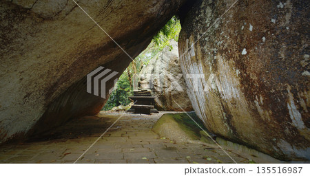 Serene Buddha Statue Nestled Among Enormous Rocks Serene Buddha Statue Nestled Among Enormous Rocks 135516987
