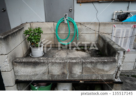 Faucet and sink at the eaves of an old house Faucet and sink at the eaves of an old house 135517145