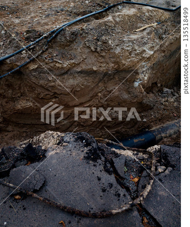 deep trench with old pipe. 135518499