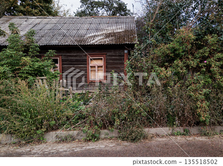 Deserted old wooden house decaying in the countryside Deserted old wooden house decaying in the countryside 135518502