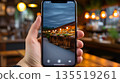 Smartphone screen showing a restaurant at night 135519261