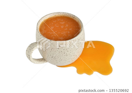 Pumpkin juice in a cup and on the table. Pumpkin juice in a cup and on the table. 135520692