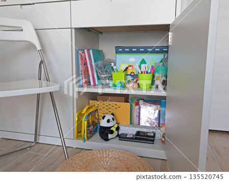 New modern children toys in white cupboard on shelf. Cleaning and storage in home. Design and order.  135520745