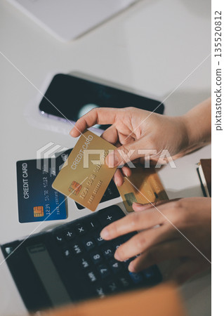 Online payment, Hands of woman holding a credit card and using smart phone for online shopping 135520812