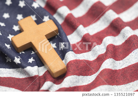 Wooden cross on wavy American flag 135521097