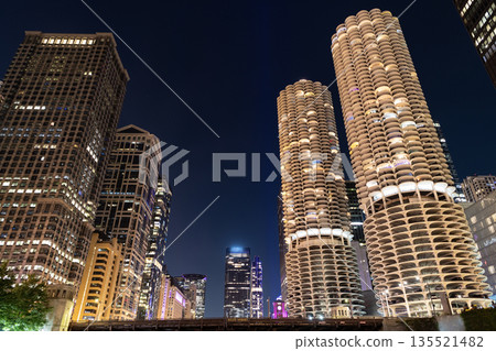 Night cityscape of Chicago skyscraper building. Chicago architecture of skyscraper. City night illuminated building. Skyscraper cityscape. Night city of Chicago. Business city. Crisp night air Night cityscape of Chicago skyscraper building. Chicago architecture of skyscraper. City night illuminated building. Skyscraper cityscape. Night city of Chicago. Business city. Crisp night air 135521482