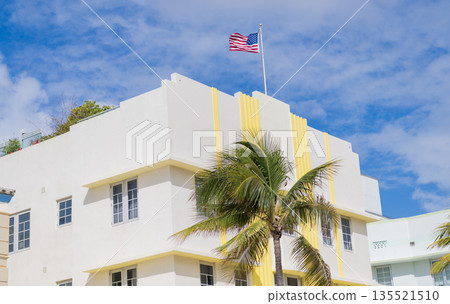 Architectural district Art Deco. Modern building of Miami beach. Ocean drive. Miami Beach in Ocean Drive Florida. Art Deco building architecture. Architectural building. Art deco. American flag Architectural district Art Deco. Modern building of Miami beach. Ocean drive. Miami Beach in Ocean Drive Florida. Art Deco building architecture. Architectural building. Art deco. American flag 135521510