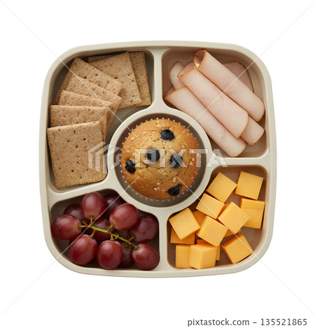 Balanced, healthy lunchbox meal prep with whole grain crackers, sliced meat, cheese, a blueberry muffin, and fresh grapes, isolated 135521865