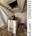Dismantling a vintage stove in an old house. The firebox door and ash door are visible. The stove is in an emergency condition. Dismantling a vintage stove in an old house. The firebox door and ash door are visible. The stove is in an emergency condition. 135521912