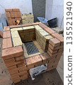 Fresh brickwork of a heating stove. The firebox is made of fireclay brick. The masonry is reinforced with wire. Fresh brickwork of a heating stove. The firebox is made of fireclay brick. The masonry is reinforced with wire. 135521940