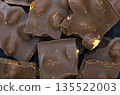 Background of chocolate. Chocolate with hazelnut. 135522003
