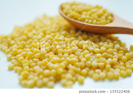 Pearl couscous on a white background, close-up 135522408