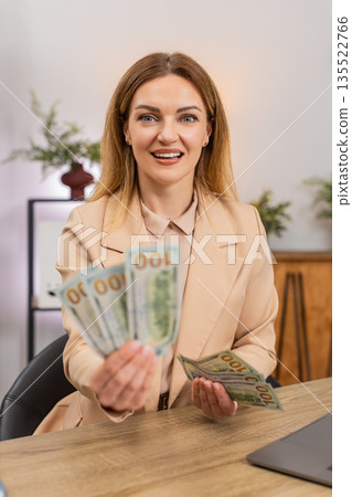 Businesswoman counts cash dollars in hand amazed by salary income bonus raise profit stack happy big Businesswoman counts cash dollars in hand amazed by salary income bonus raise profit stack happy big 135522766