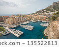 Panoramic view of Monaco harbor with luxury yachts, waterfront buildings and Mediterranean coastline 135522813