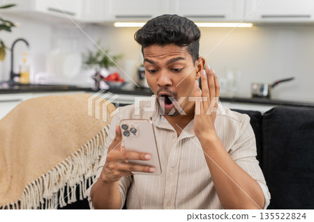 Indian man watches wow video reacts with shock eyes laughs shares link to friends in messenger chat Indian man watches wow video reacts with shock eyes laughs shares link to friends in messenger chat 135522824