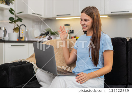 Young woman does video interview on laptop answers well keeps webcam contact smiles nods thanks live Young woman does video interview on laptop answers well keeps webcam contact smiles nods thanks live 135522889