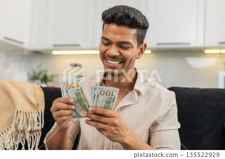 Indian man counts dollar cash feel happy makes money gesture plans dream purchase savings invest aim Indian man counts dollar cash feel happy makes money gesture plans dream purchase savings invest aim 135522929