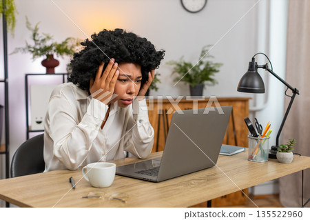 African American businesswoman disappointed sees laptop screen after game loss news client rejection African American businesswoman disappointed sees laptop screen after game loss news client rejection 135522960