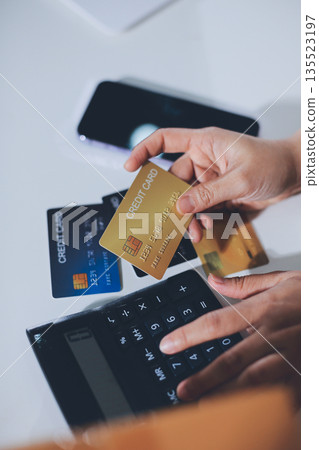 Online payment, Hands of woman holding a credit card and using smart phone for online shopping Online payment, Hands of woman holding a credit card and using smart phone for online shopping 135523197