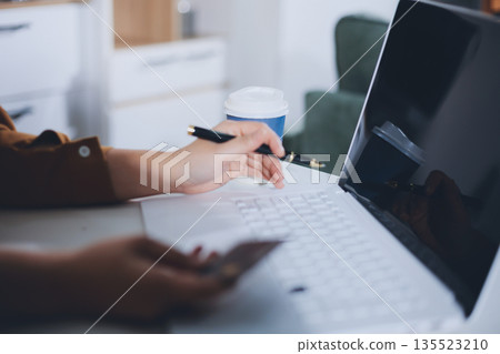 Online payment, Hands of woman holding a credit card and using smart phone for online shopping Online payment, Hands of woman holding a credit card and using smart phone for online shopping 135523210
