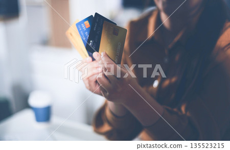 Online payment, Hands of woman holding a credit card and using smart phone for online shopping Online payment, Hands of woman holding a credit card and using smart phone for online shopping 135523215