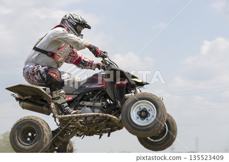 Ukraine Motocross Championship in 2016. Racer while jumping a quad bikeon. Ukraine Motocross Championship in 2016. Racer while jumping a quad bikeon. 135523409